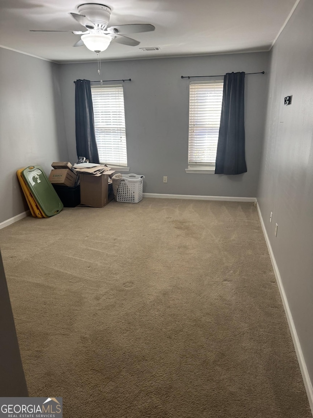 spare room featuring carpet and ceiling fan