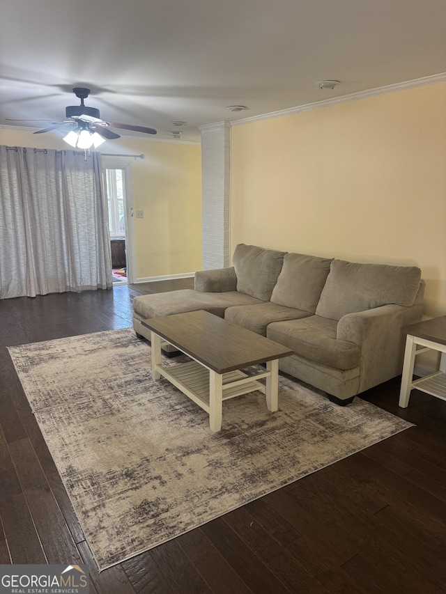 living room featuring dark hardwood / wood-style floors, ceiling fan, and crown molding