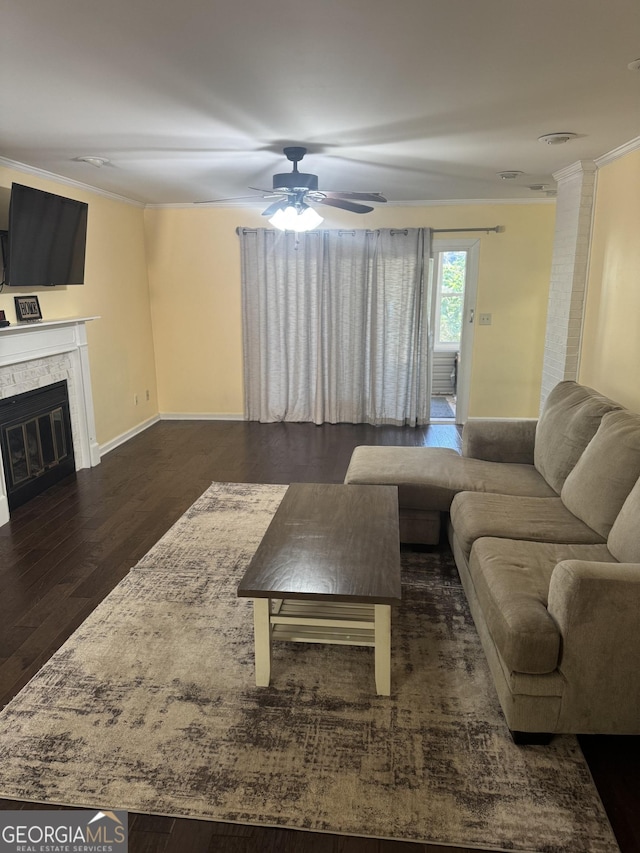 living room with ceiling fan, dark hardwood / wood-style floors, and ornamental molding