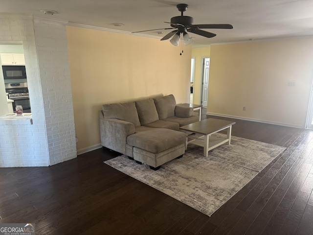 living room featuring ceiling fan, dark hardwood / wood-style flooring, and ornamental molding