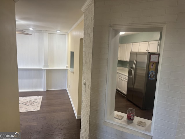 corridor featuring dark hardwood / wood-style flooring and ornamental molding