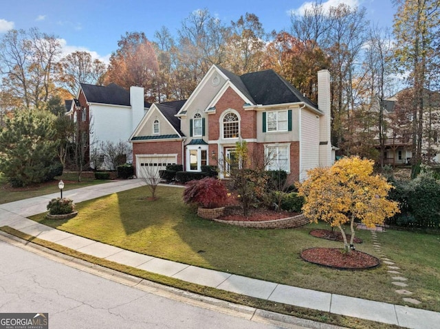 front facade with a garage and a front lawn