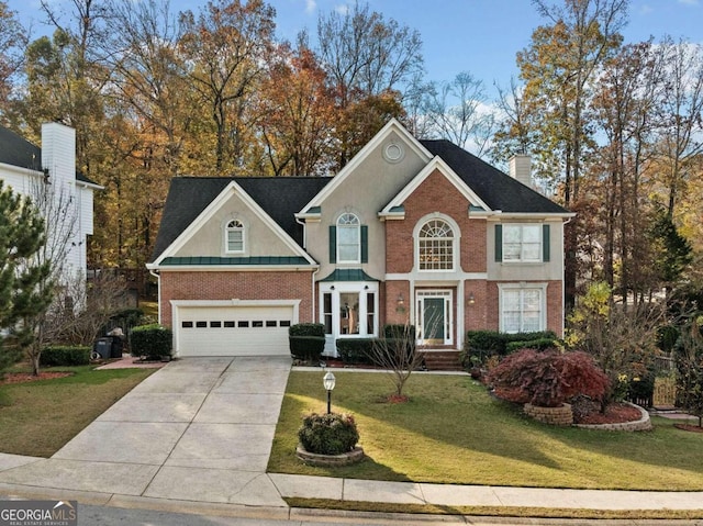 view of front of house featuring a front yard and a garage