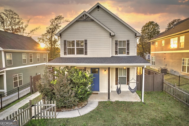 view of front of house with a lawn and a patio area