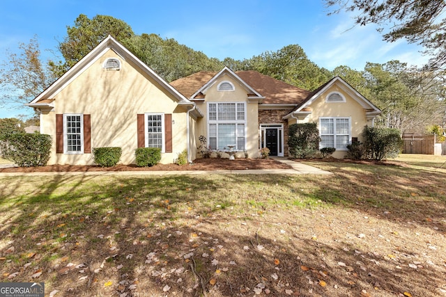 ranch-style home featuring a front yard