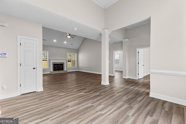 unfurnished living room featuring ceiling fan, a fireplace, high vaulted ceiling, and light hardwood / wood-style floors