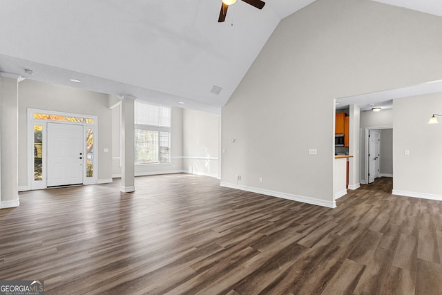 unfurnished living room with dark hardwood / wood-style floors, ceiling fan, and high vaulted ceiling