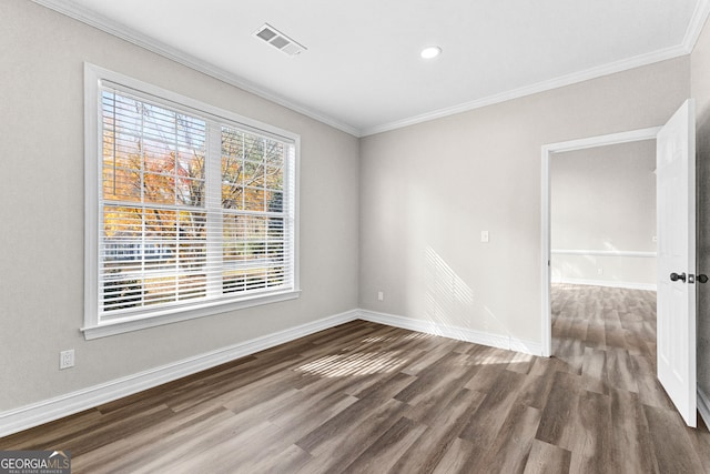 spare room with dark hardwood / wood-style flooring and ornamental molding