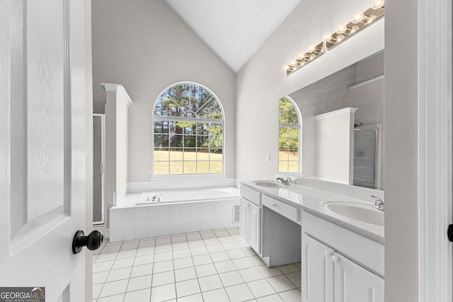 bathroom with shower with separate bathtub, vanity, vaulted ceiling, and tile patterned floors