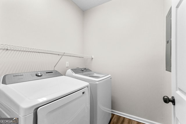 washroom with washer and clothes dryer, dark wood-type flooring, and a textured ceiling