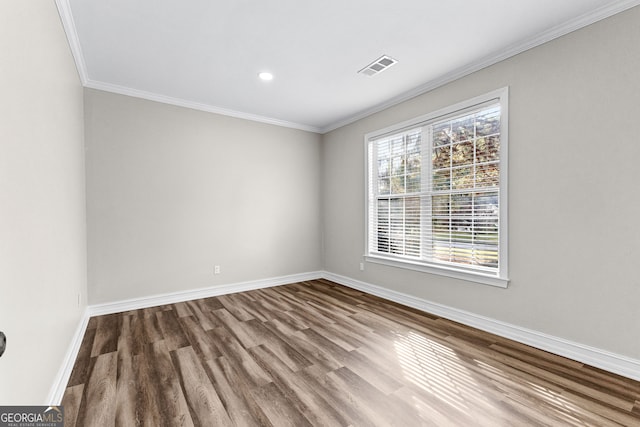 spare room featuring wood-type flooring and ornamental molding