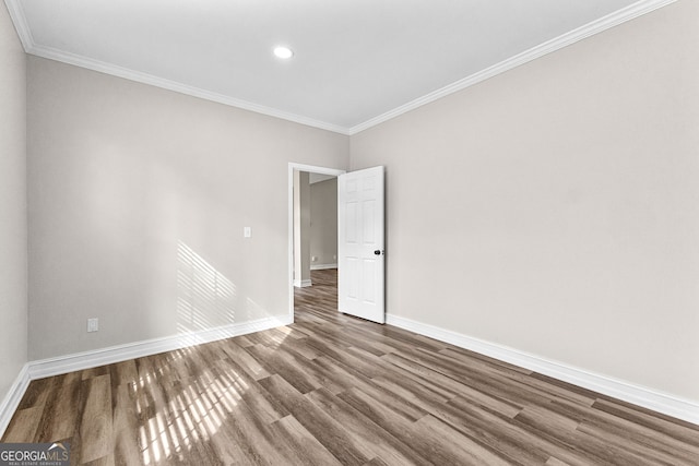 unfurnished room featuring hardwood / wood-style floors and ornamental molding