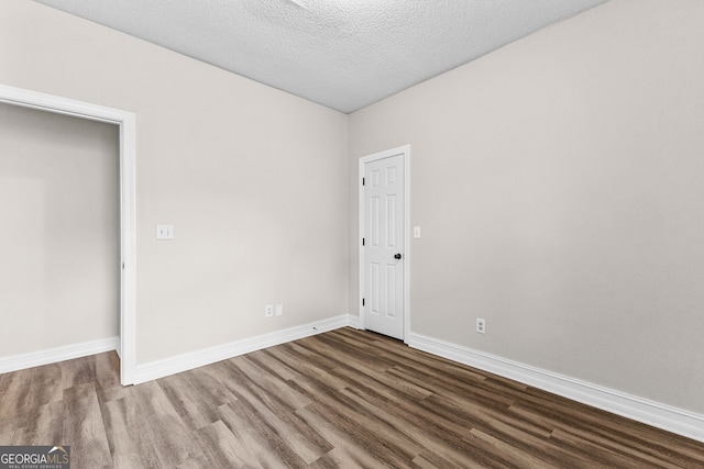 unfurnished bedroom featuring wood-type flooring and a textured ceiling