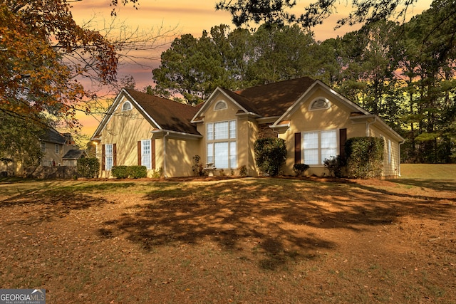 ranch-style house with a yard