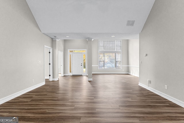 unfurnished living room featuring dark hardwood / wood-style flooring