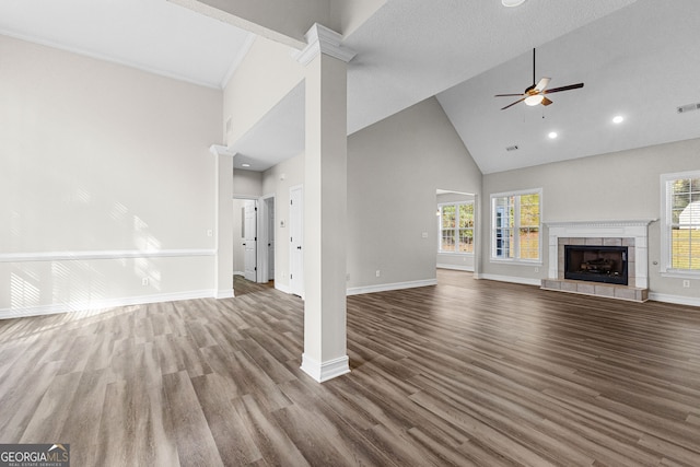 unfurnished living room featuring a wealth of natural light, hardwood / wood-style floors, and high vaulted ceiling