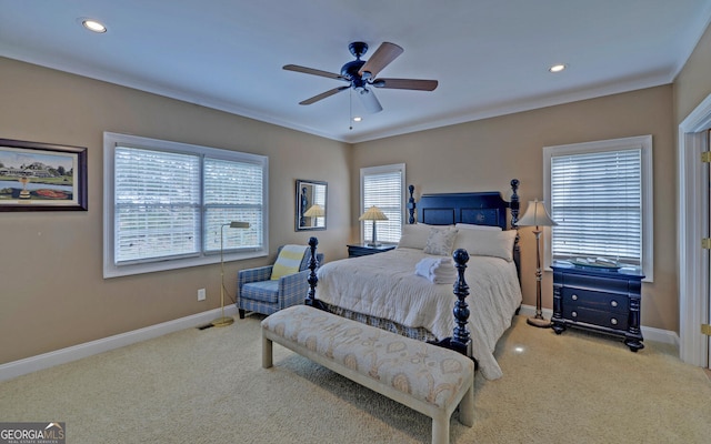 carpeted bedroom featuring multiple windows and ceiling fan