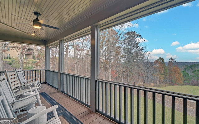 sunroom / solarium featuring ceiling fan, wood ceiling, and vaulted ceiling