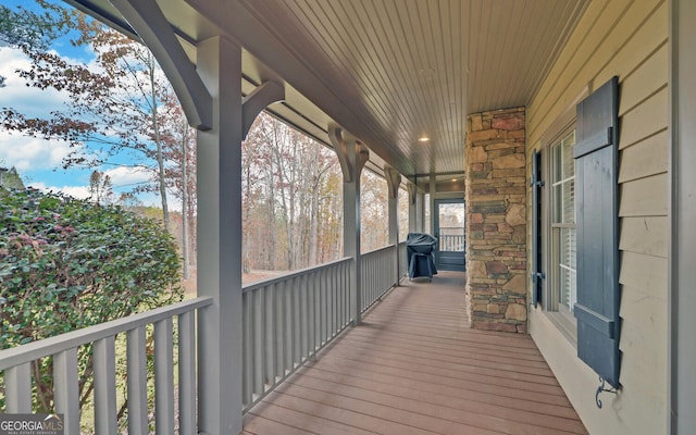 wooden deck featuring covered porch and grilling area