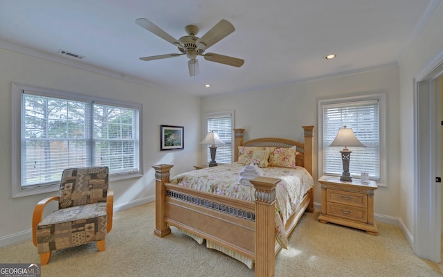 carpeted bedroom with multiple windows, crown molding, and ceiling fan