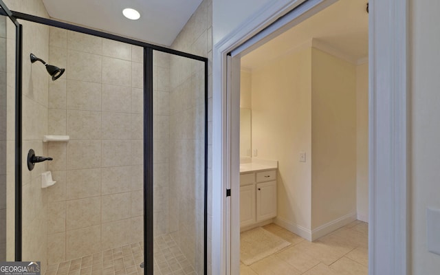 bathroom featuring tile patterned flooring, vanity, and a shower with door