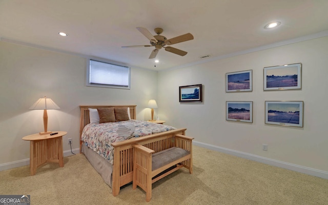 carpeted bedroom with ceiling fan and crown molding