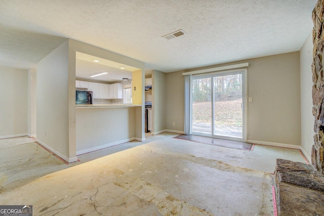 unfurnished living room with a textured ceiling