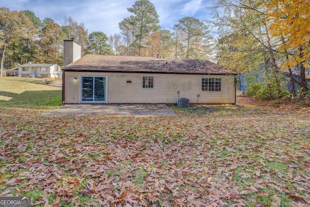 5267 Tasman Trl, Lithonia, GA 30038 - back of house featuring a patio area, central AC, a chimney, and a yard