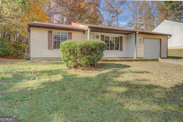 single story home featuring a garage and a front yard