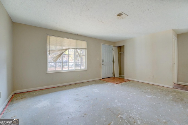 spare room with a textured ceiling