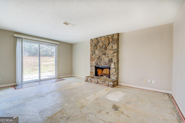 unfurnished living room featuring a fireplace and a textured ceiling