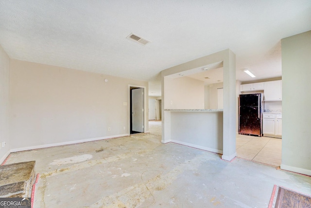 unfurnished room featuring a textured ceiling