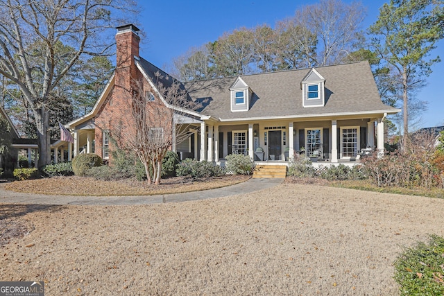 new england style home with a porch