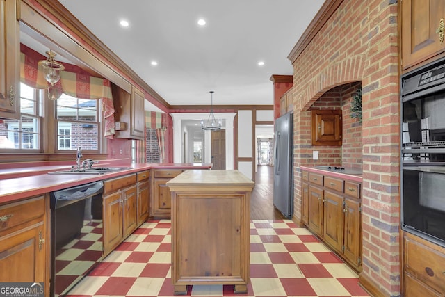 kitchen with butcher block counters, sink, crown molding, a kitchen island, and black appliances