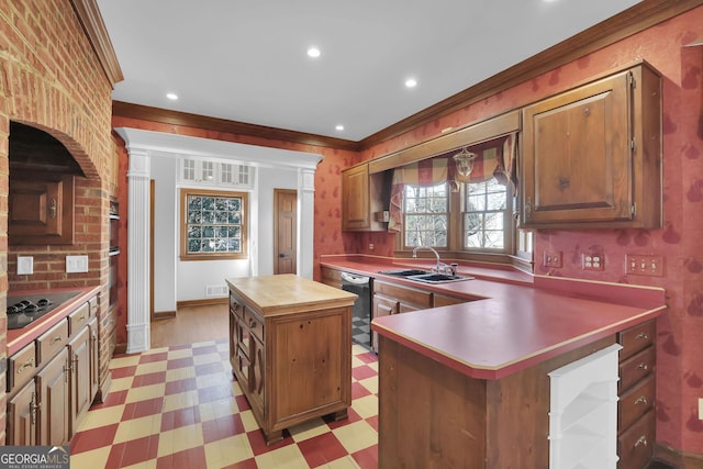 kitchen featuring crown molding, a center island, black appliances, and sink