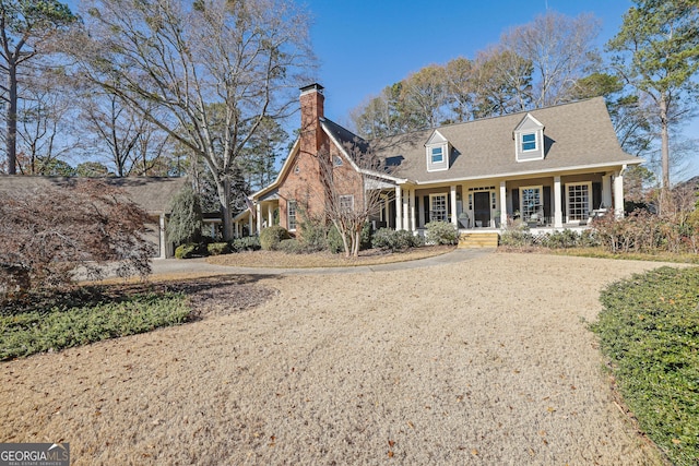 cape cod home featuring a porch