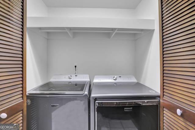 clothes washing area featuring washer and dryer