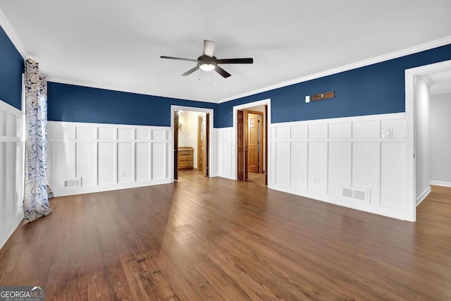 unfurnished bedroom featuring ceiling fan, dark hardwood / wood-style flooring, and crown molding