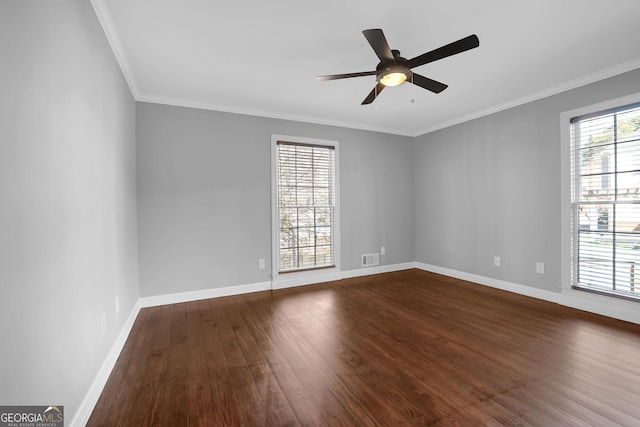 empty room with plenty of natural light, ceiling fan, wood-type flooring, and ornamental molding