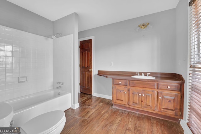 full bathroom with wood-type flooring, vanity, toilet, and tub / shower combination