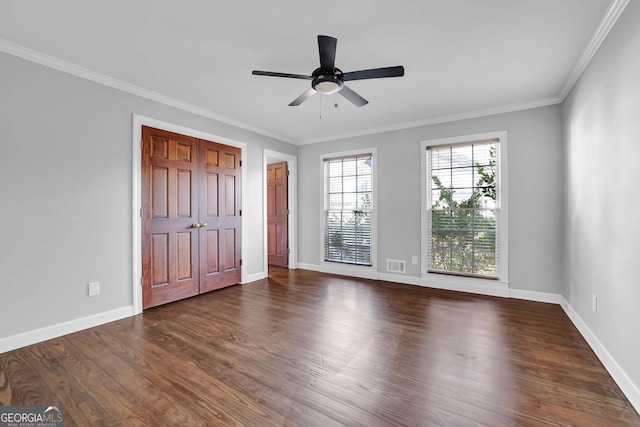 unfurnished bedroom with ceiling fan, crown molding, and dark hardwood / wood-style floors