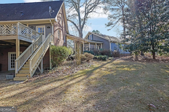 exterior space with a lawn and a wooden deck