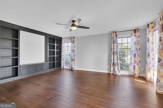 spare room with ceiling fan, built in features, and dark wood-type flooring