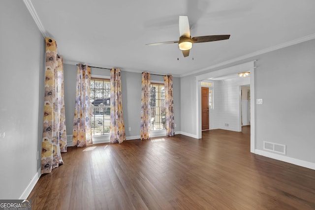 spare room featuring crown molding, dark hardwood / wood-style flooring, and ceiling fan