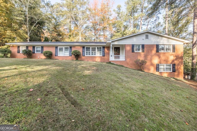 single story home with covered porch and a front lawn