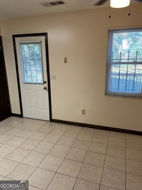 entryway featuring ceiling fan and light tile patterned flooring