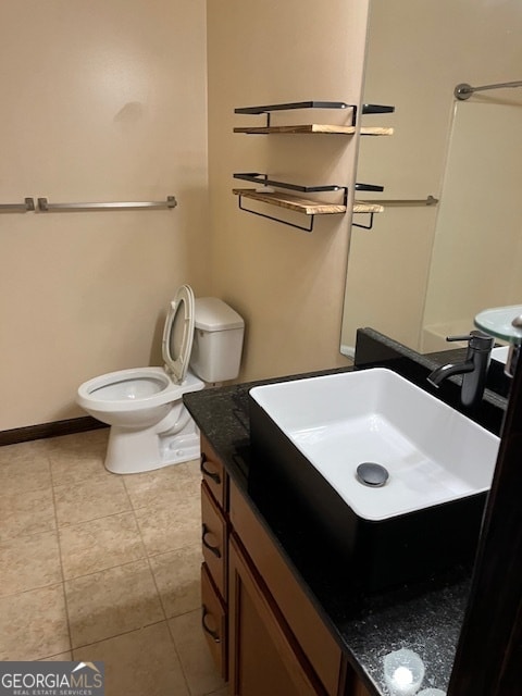 bathroom with tile patterned floors, vanity, and toilet