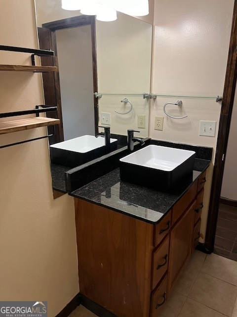 bathroom featuring tile patterned flooring and vanity