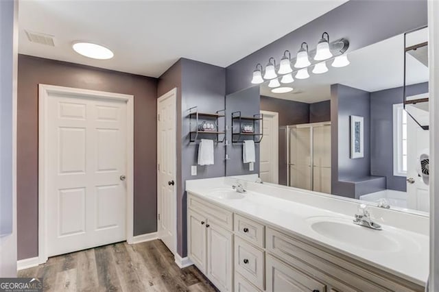 bathroom with vanity, shower with separate bathtub, and wood-type flooring