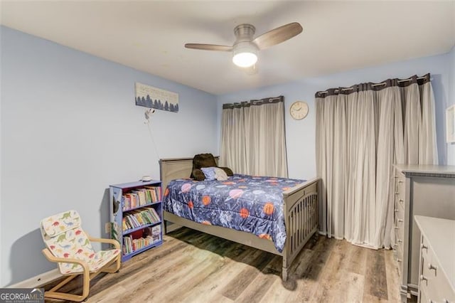 bedroom with ceiling fan and light hardwood / wood-style floors